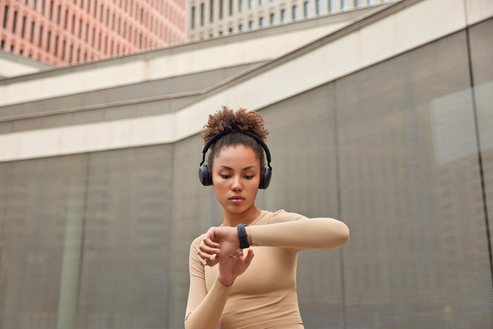 Young Woman Checking her Smart Watch Device after her workout